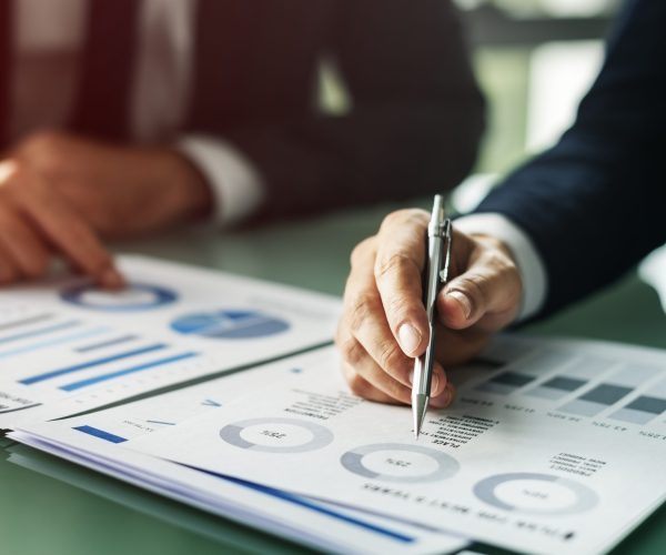 Hands Writing Business Documents Desk Concept